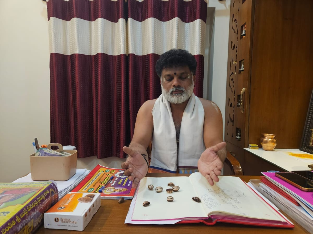 Palm Reader and astrologer Guruji consulting a client at the centre
